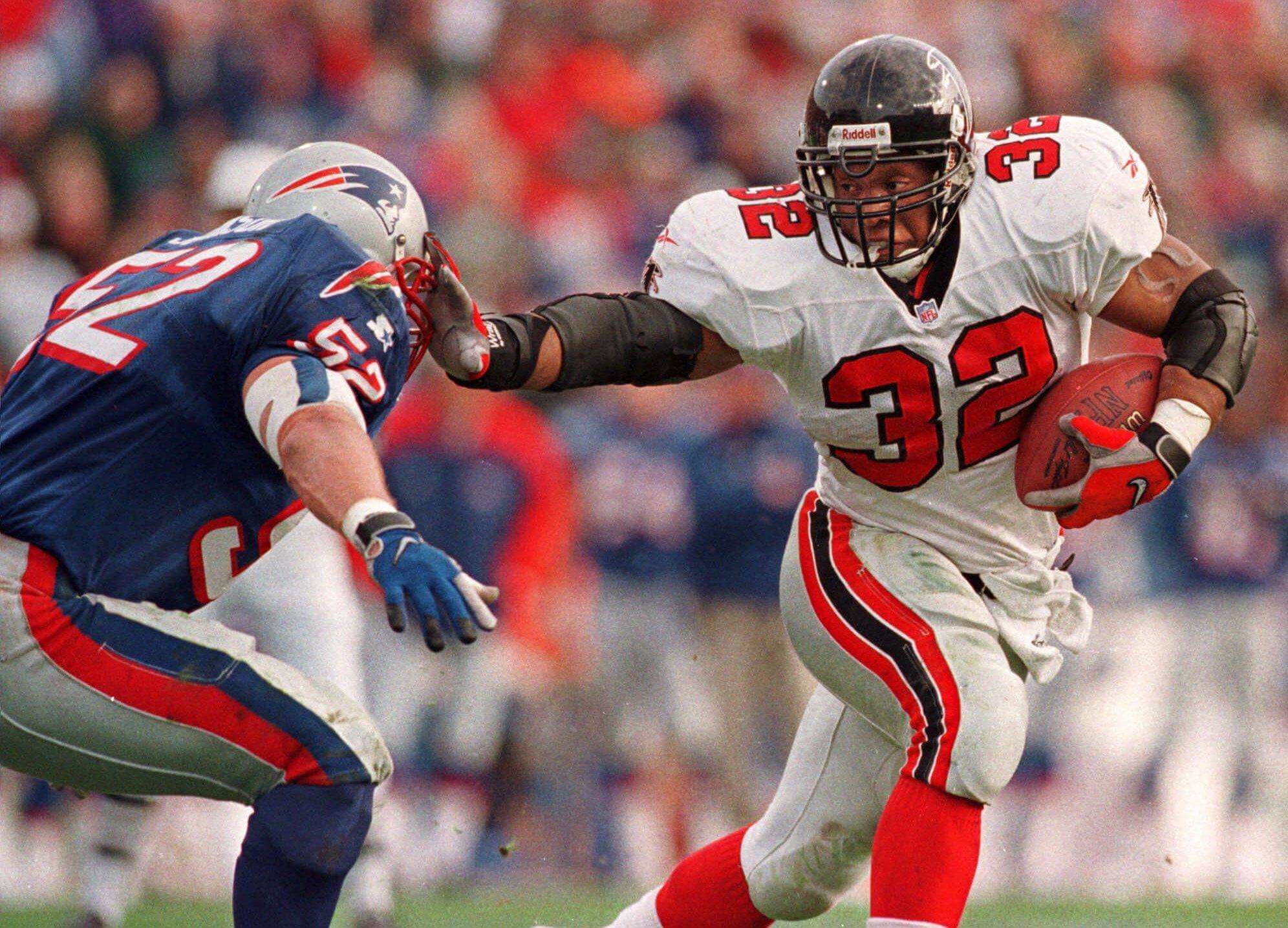 Atlanta Falcons running back Jamal Anderson (32) straight-arms New England Patriots linebacker Ted Johnson (52) in route to a second quarter touchdown at Foxboro Stadium in Foxboro, Mass., Sunday afternoon Nov. 8, 1998. The Falcons can do something even more unusual on Sunday. If they beat San Francisco, they'll be alone in first place the NFC West this late for the first time since 1980. The game is so big that it's a rare sellout at the Georgia Dome and one ofthe few times the Falcons are the attraction, not the 49ers. (AP Photo/Winslow Townson)