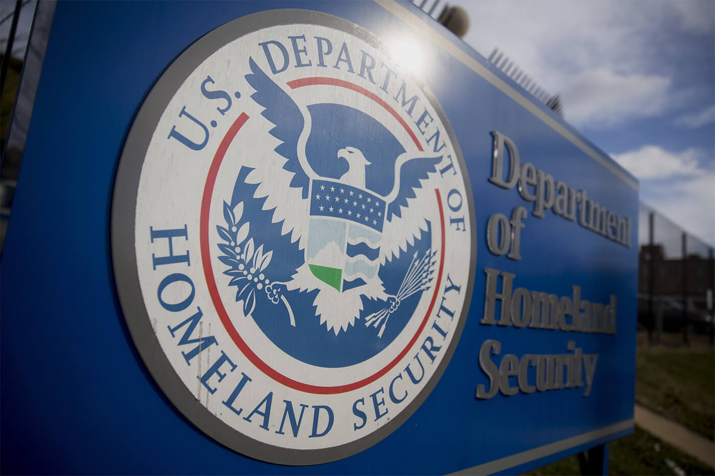 A U.S. Department of Homeland Security (DHS) sign stands at the agency's headquarters in Washington, D.C., U.S., on Thursday, Dec. 11, 2014. The U.S. House is set to pass a $1.1 trillion spending bill that includes a banking provision opposed by many Democrats as a giveaway to large institutions. Current funding for the government ends today, and the measure would finance most of the government through September 2015. The DHS, responsible for immigration policy, would be financed only through Feb. 27. Photographer: Andrew Harrer/Bloomberg via Getty Images