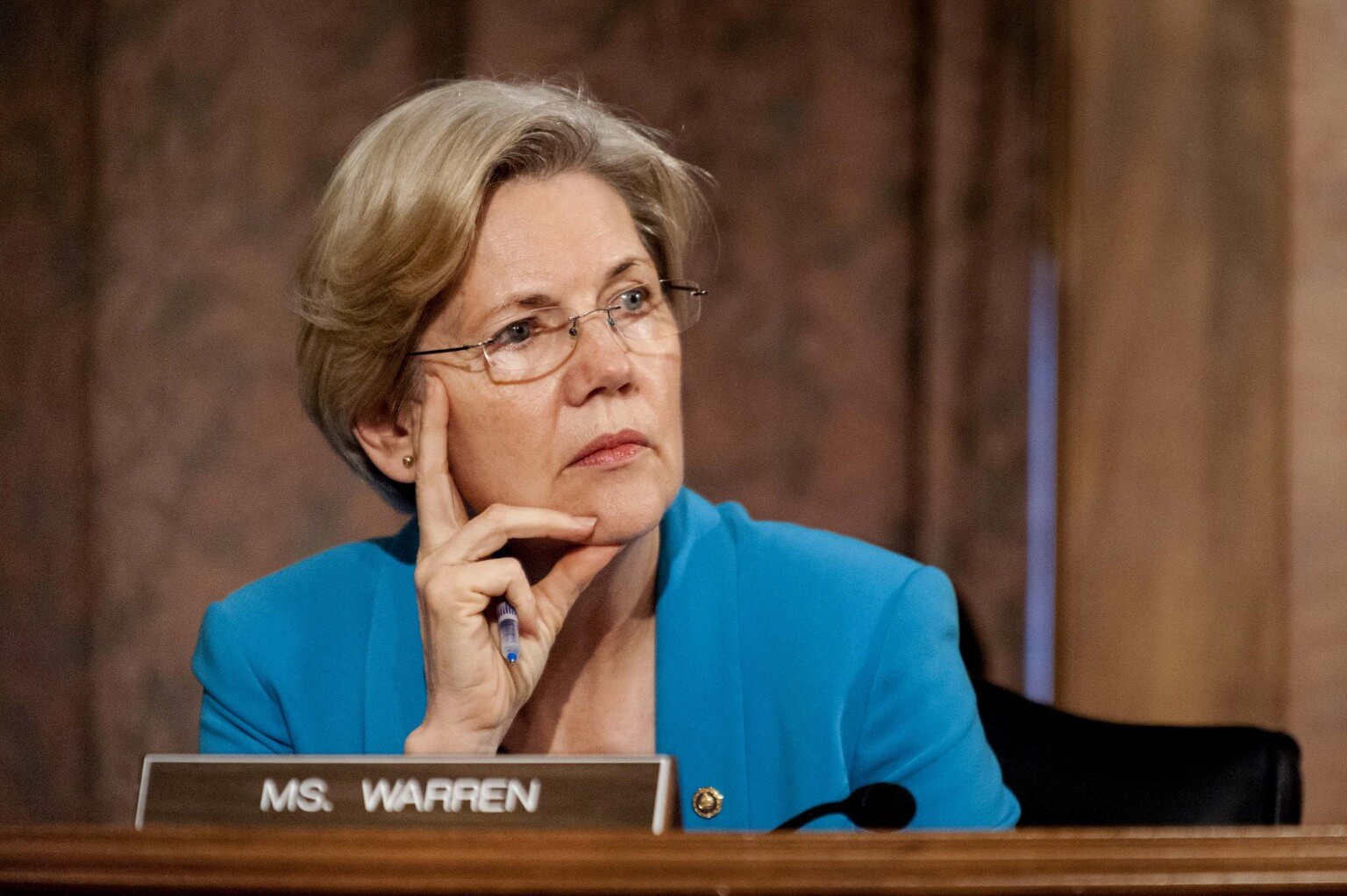 Senator Elizabeth Warren, a Democrat from Massachusetts, listens as Ben S. Bernanke, chairman of the U.S. Federal Reserve, not seen, answers a question during his semi-annual monetary policy report to the Senate Banking, Housing and Urban Affairs Committee during a hearing on Capitol Hill, in Washington, D.C., U.S., on Thursday, July 18, 2013. Bernanke said one reason for the recent rise in long-term interest rates is the unwinding of leveraged and "excessively risky" investing. Photographer: Pete Marovich/Bloomberg via Getty Images