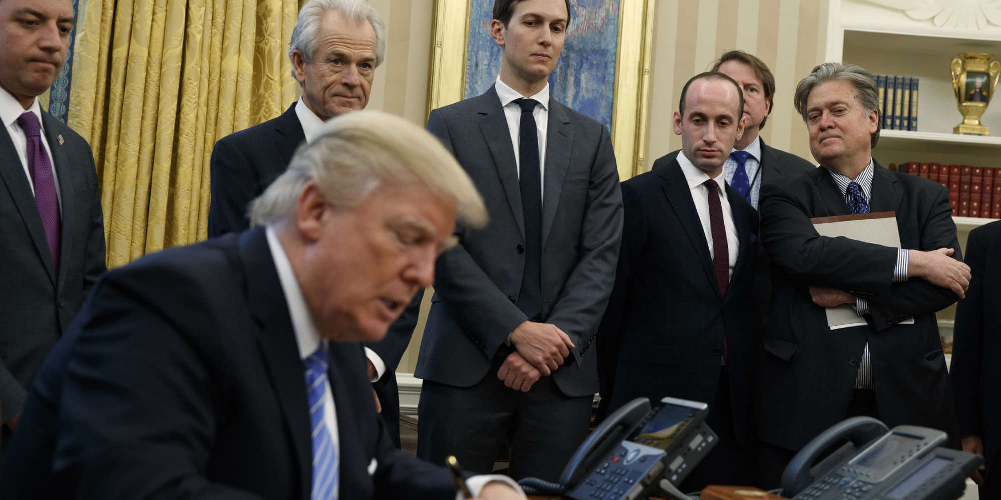 From left, White House Chief of Staff Reince Priebus, National Trade Council adviser Peter Navarro, Senior Adviser Jared Kushner, policy adviser Stephen Miller, and chief strategist Steve Bannon watch as President Donald Trump signs an executive order in the Oval Office of the White House, Monday, Jan. 23, 2017, in Washington. (AP Photo/Evan Vucci)